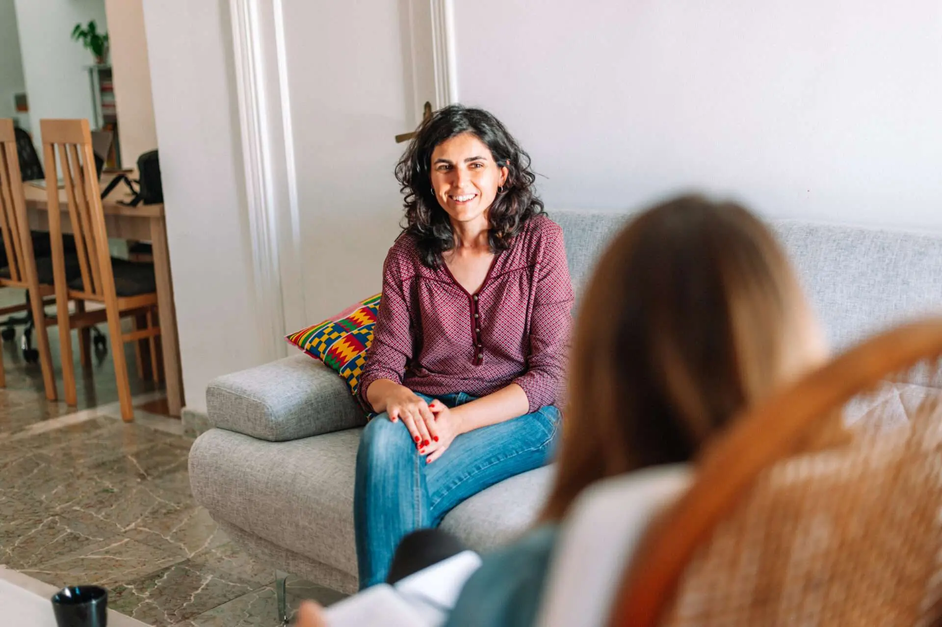 Smiling therapist welcoming a client to a session