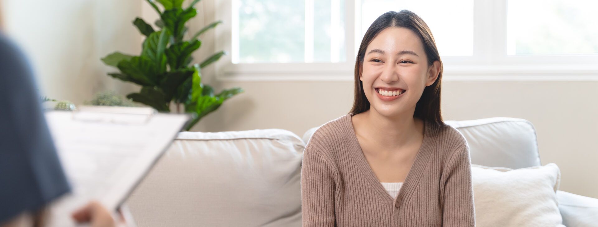 client and therapist sitting together in a calm, light-filled space, symbolizing the safety and connection that support emotional healing and self-acceptance.