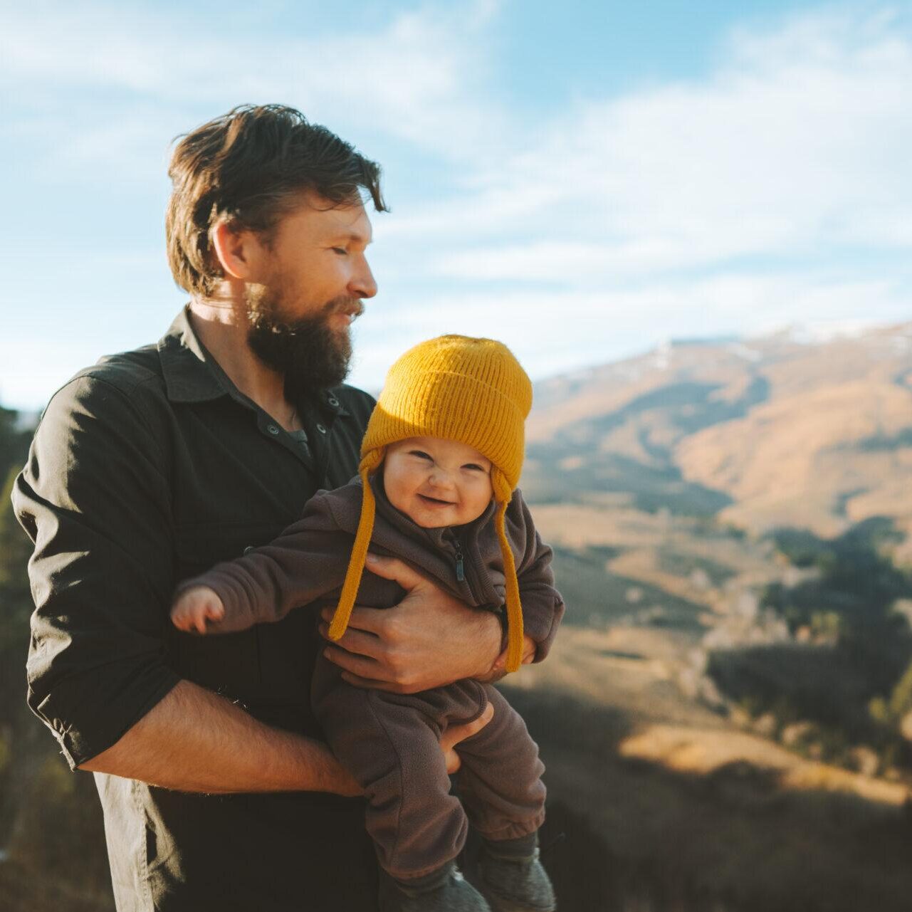 father outdoors with baby is getting counseling help for relationship issues in Reno NV