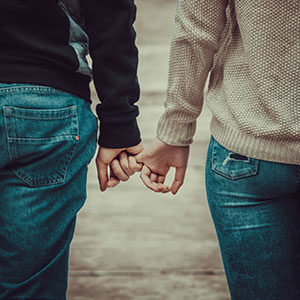 marriage counseling Reno, NV couple walking outdoors, holding hands.