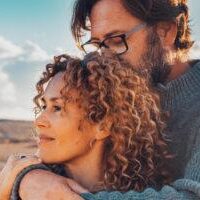 relationship counseling reno, nv with Cornelius Sheehan, LCSW. couple counseling clients embrace, outdoors. Therapy in Reno