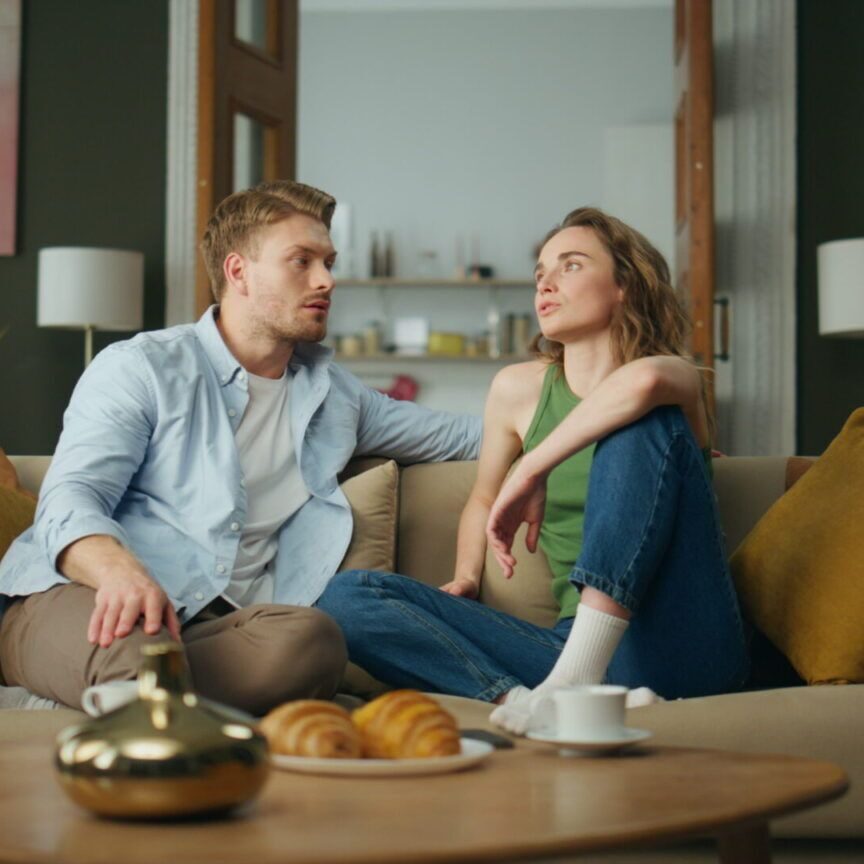 Calm family talking sofa at living room. Relaxed boyfriend girlfriend chilling young couple exploring help for relationship issues in reno, nv